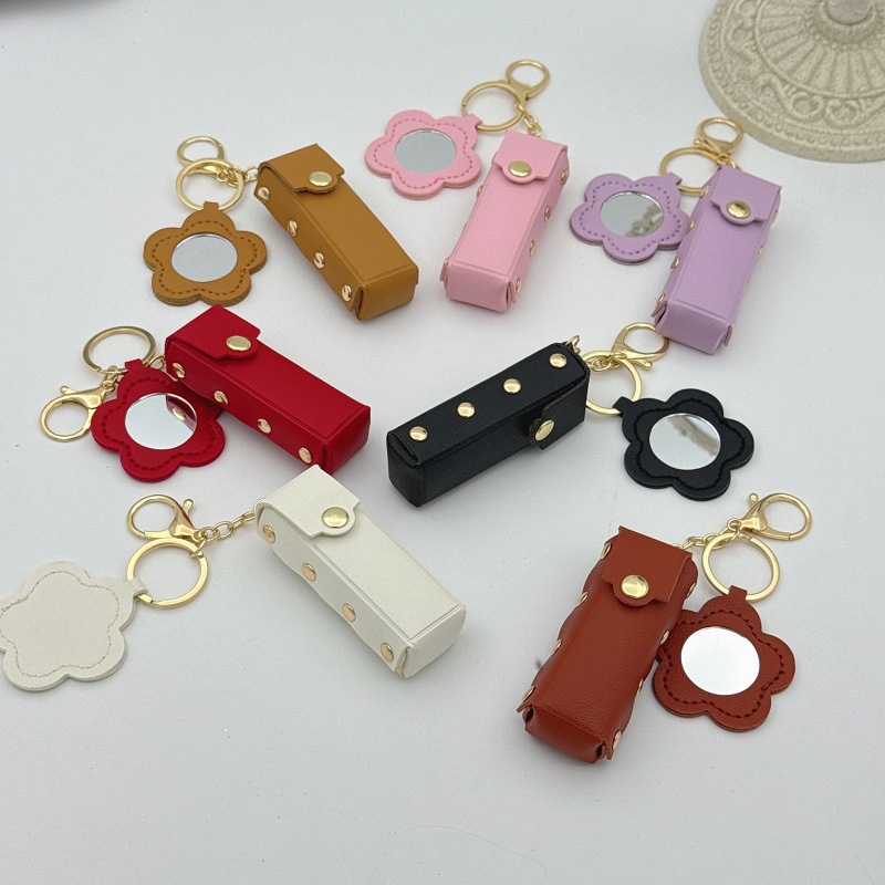 Móc khoá gương mini trang điểm kèm túi đựng son. Kích thước: 9*3cm. Có 2 shape gương: Hình bông hoa | Hình trái tim. In Logo theo yêu cầu